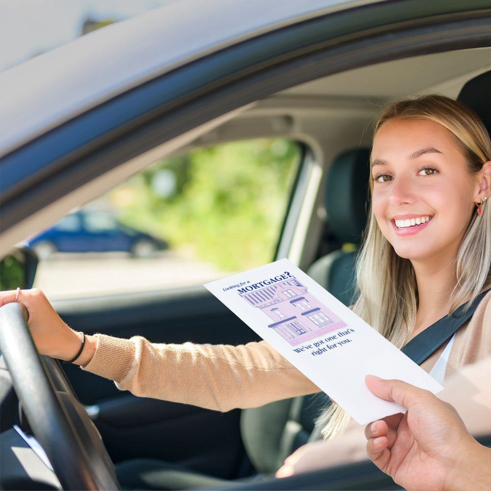 Drive up envelope shown in use with bank teller and banking customer 