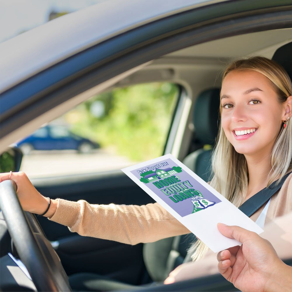 Drive up envelope shown in use with bank teller and banking customer 