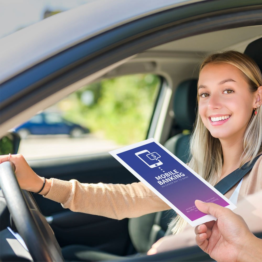 Drive up bank envelope in use with bank teller and banking customer 