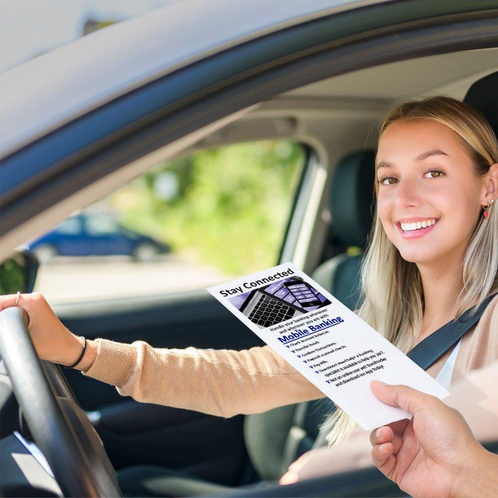 Drive thru money envelopes shown in use with bank teller and bank customer