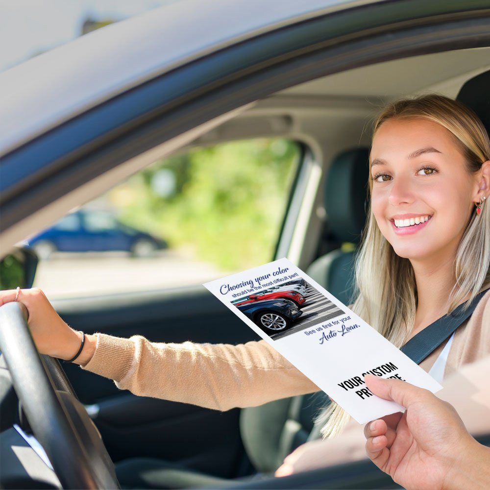 Bank customer at teller window receiving drive up envelopes for cash