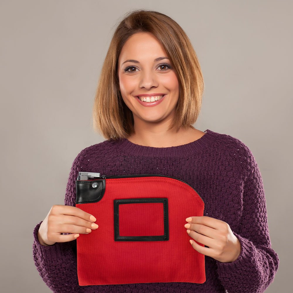 Customer holding a 10W x 8H, 14 oz Red Locking Deposit Bag made of durable cotton canvas.
