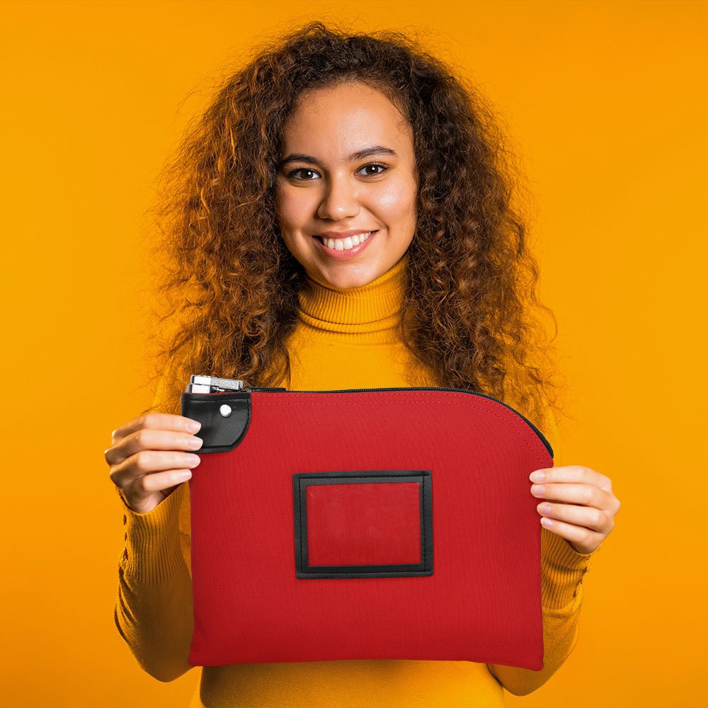 Customer holding a 12W x 9H, 14 oz Red Locking Deposit Bag made of durable cotton canvas.