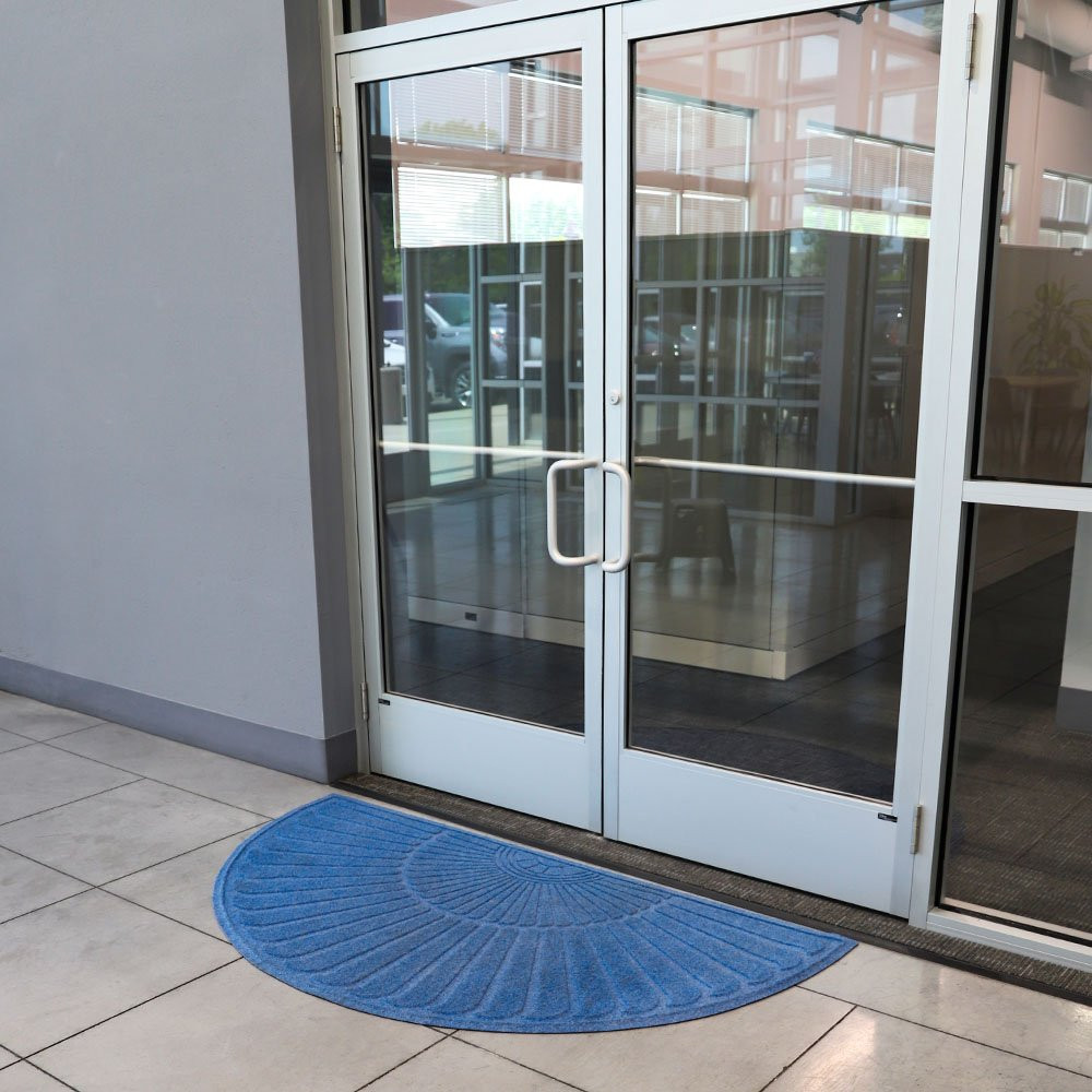 Blue mat shown in use infront of office double door  