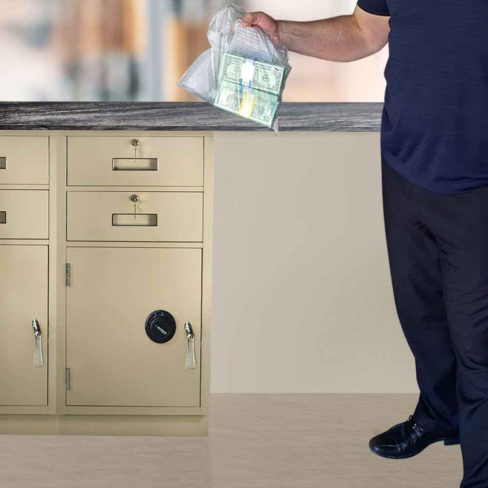 Institute employee shown with deposit ready for Fenco Teller Pedestal shown with key locking L-handle and mechanical combination