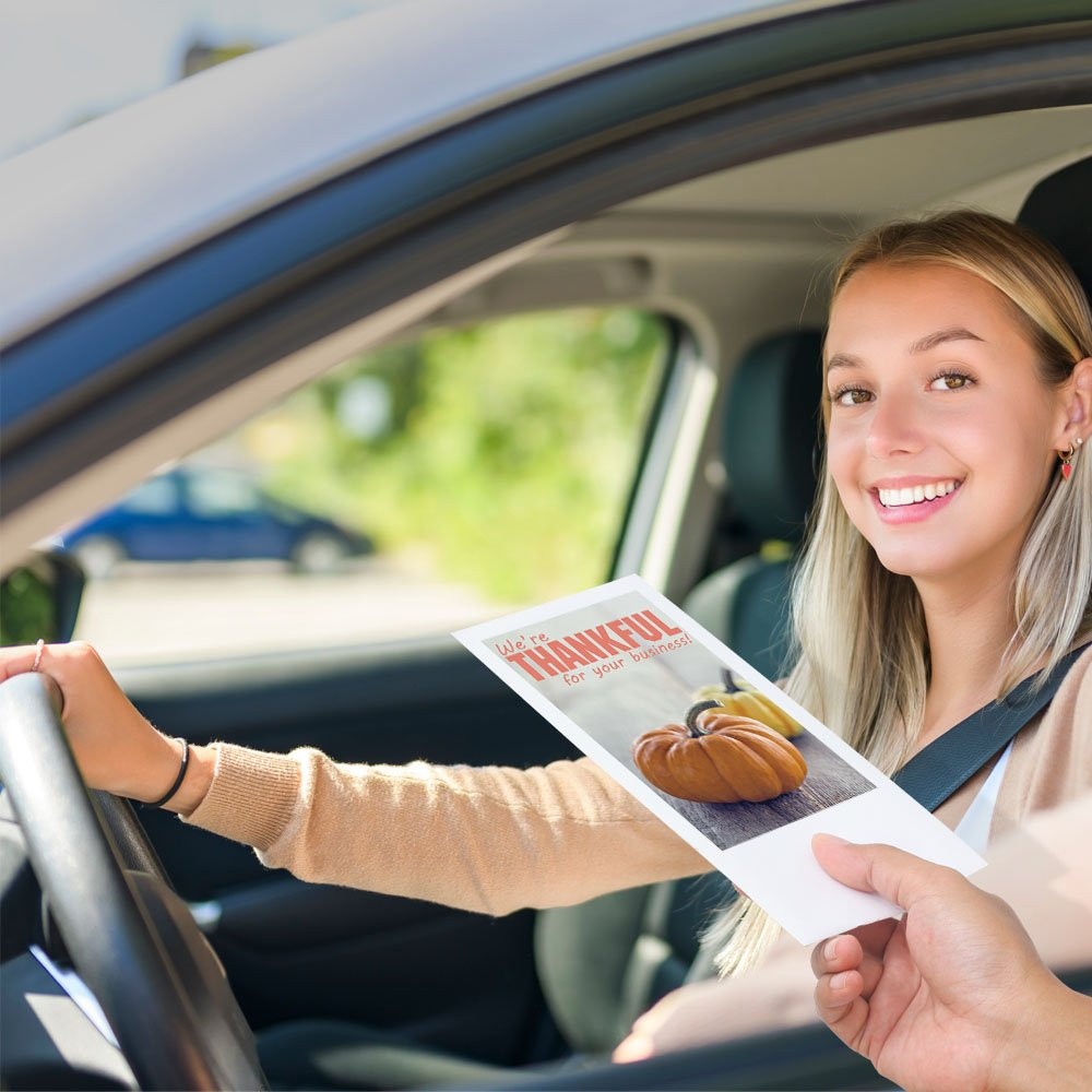 Drive thru money envelopes in use with bank teller and bank customer