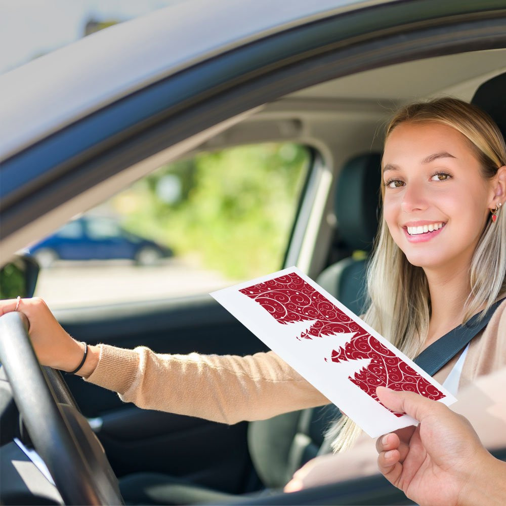 Bank customer at teller window receiving drive up money envelope 