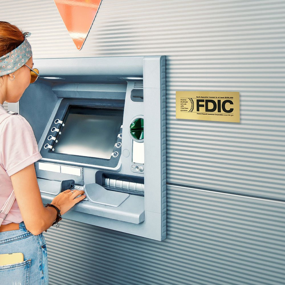 3H x 7W FDIC $250000 Limit Gold Outdoor Decal Displayed Next To An Atm